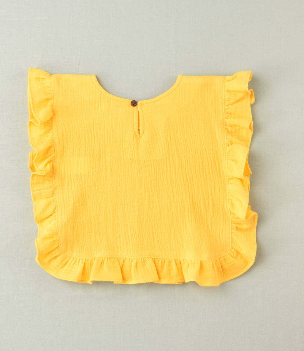 Camiseta lisa con volante amarilla niña