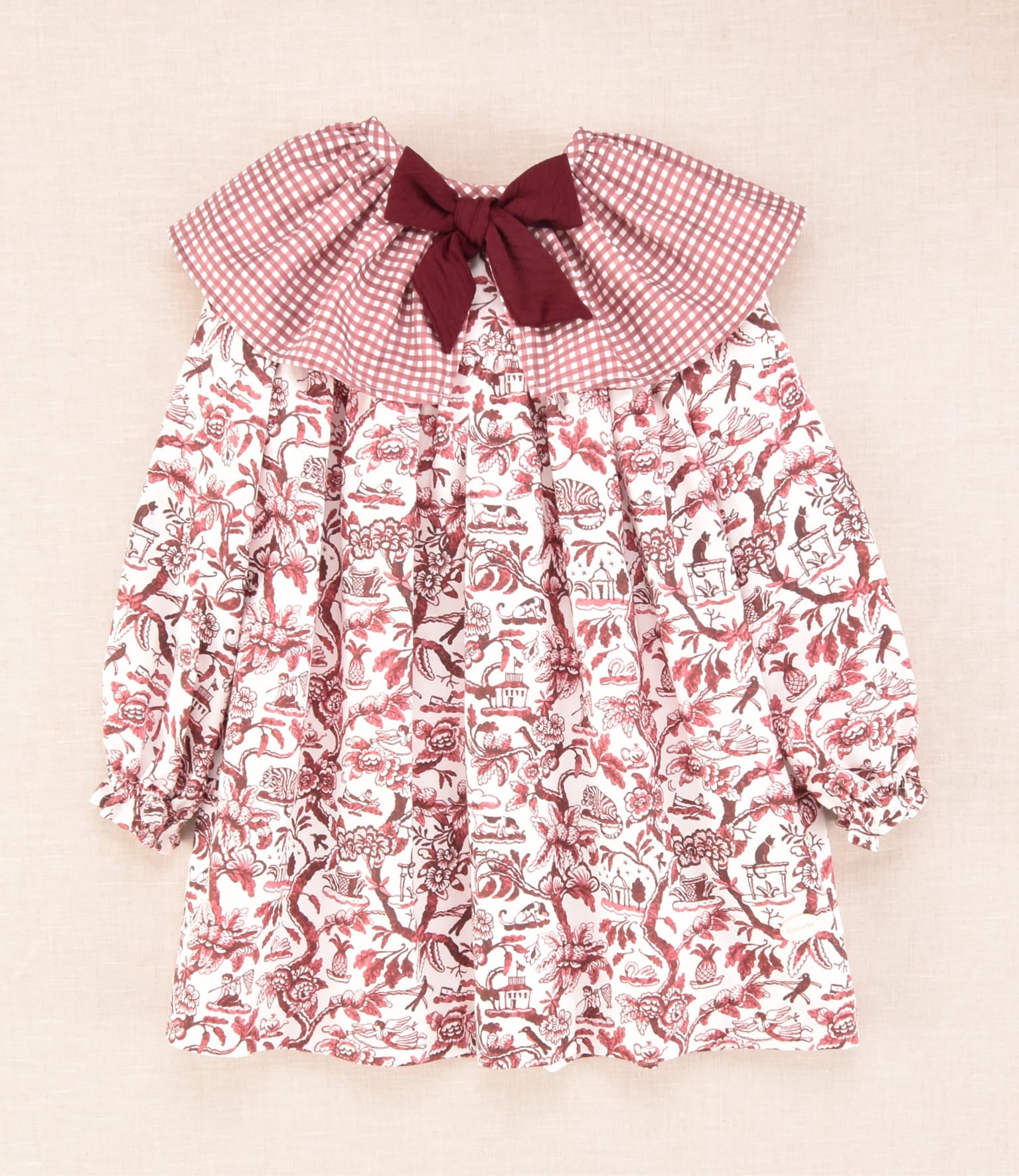 Vestido flores burdeos para niña vista frontal con volante y lazo burdeos Charanga