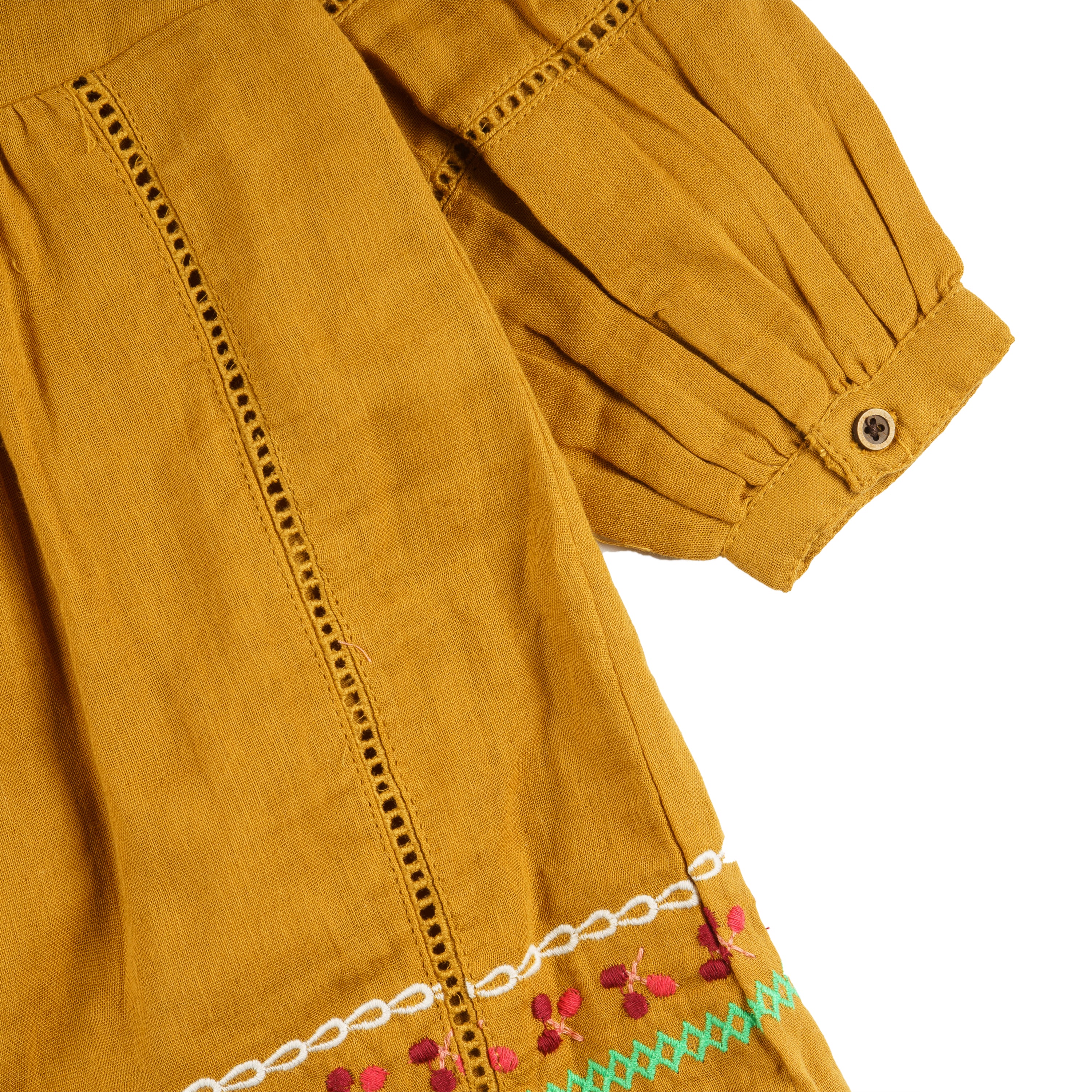 Vestido niña mostaza bambula bordado con borlas