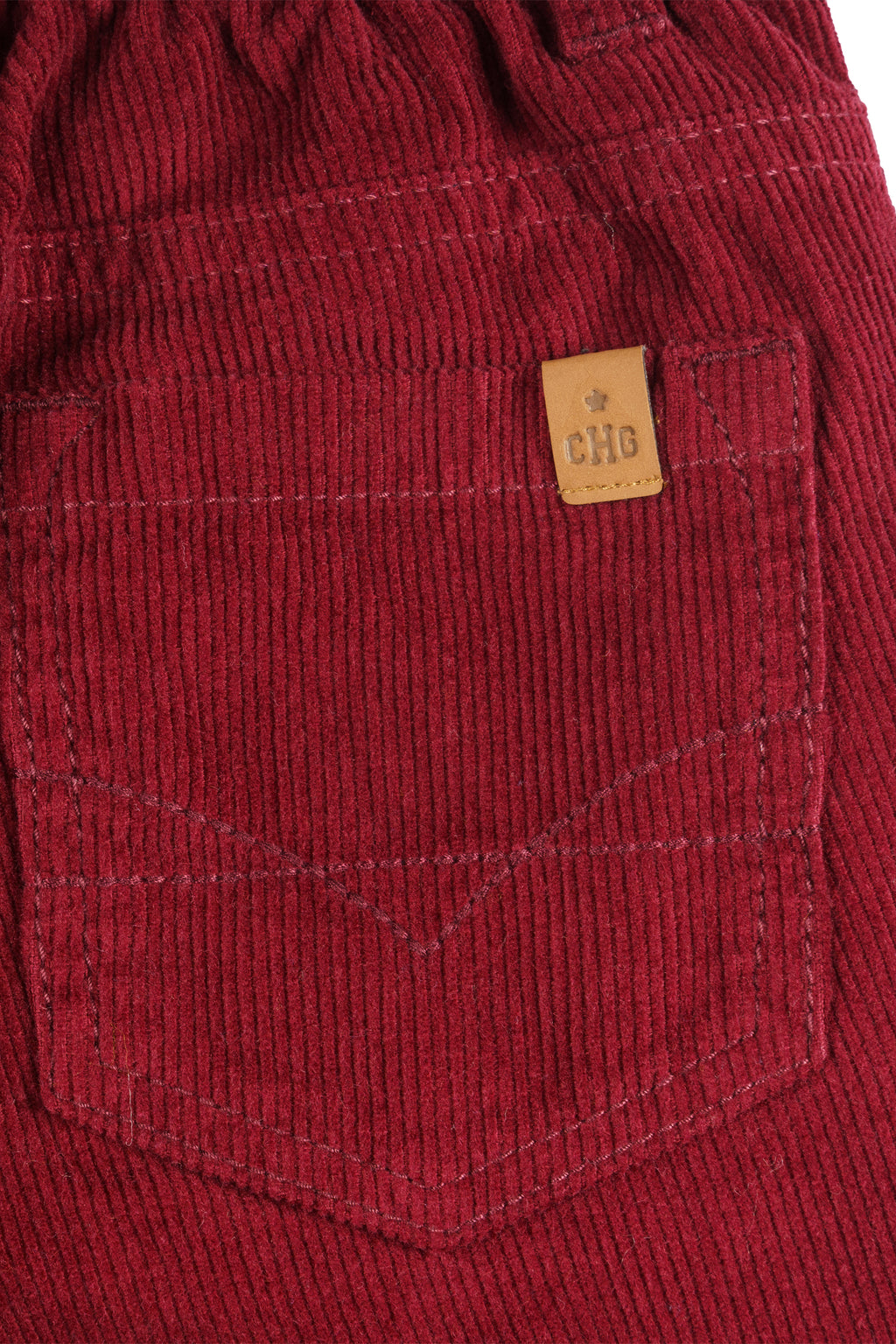 Detalle del tejido elástico del pantalón burdeos para niño Charanga