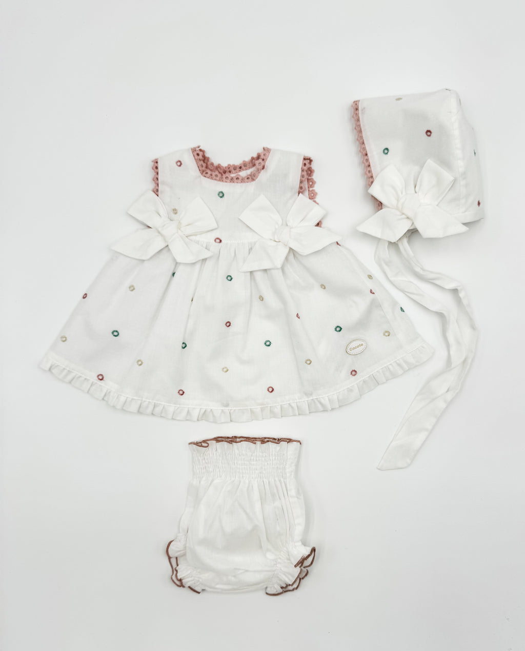 Conjunto vestido, braguita y capota perforado rosa lazos bebé | Cocote by Charanga